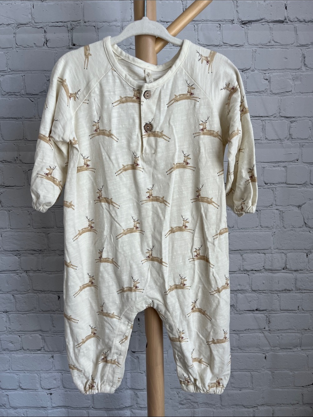 Rylee + Cru Henley Jumpsuit in a Cream Color with a reindeer print